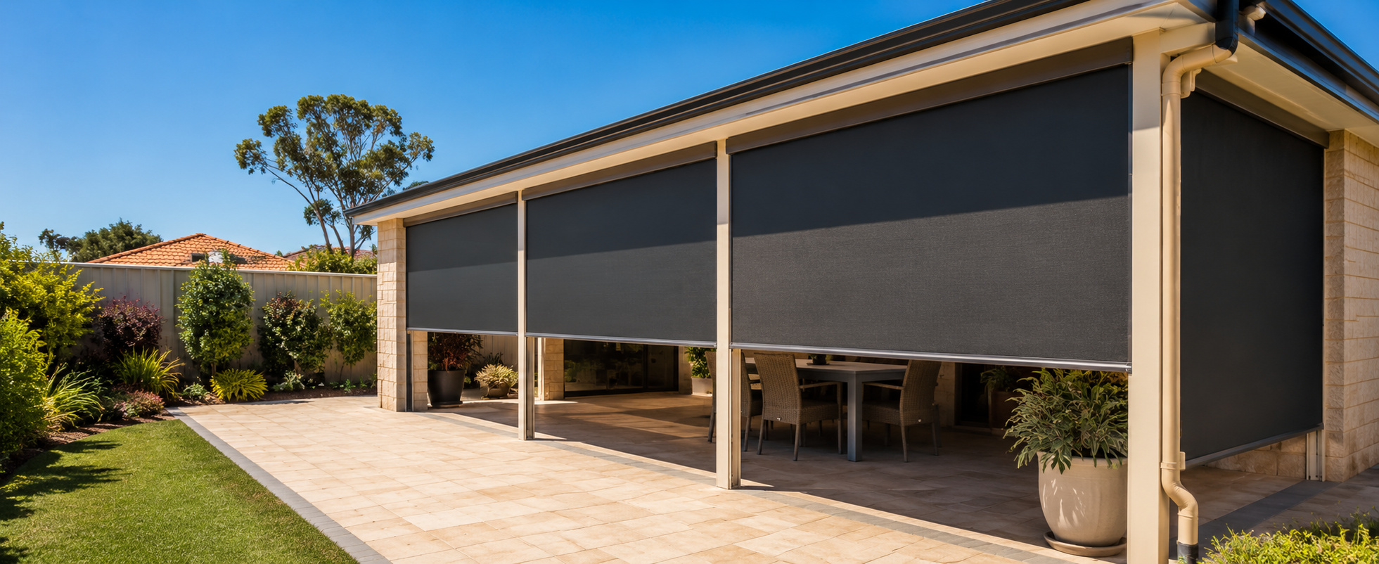Roof-to-fence blinds enclosing the open side of a Perth patio down to the garden